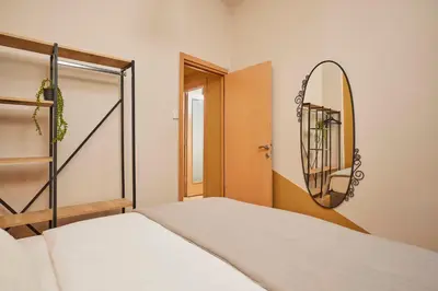 a bedroom with a bed and a mirror at Prime Nişantaşı 2BR Flat 3-Min Walk to Metro in Istanbul
