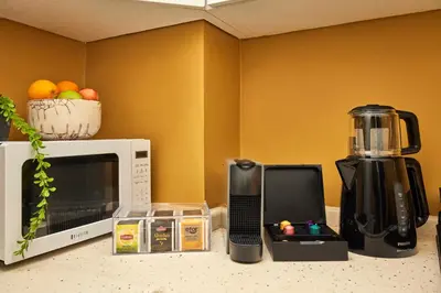 a kitchen counter with a microwave and a blender at Prime Nişantaşı 2BR Flat 3-Min Walk to Metro in Istanbul