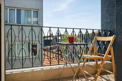 a chair and a table on a balcony at Prime Nişantaşı 2BR Flat 3-Min Walk to Metro in Istanbul
