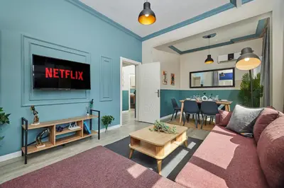 a living room with a couch and a tv at Central Nişantaşı Stay 2BR Flat AC in All Rooms in Istanbul