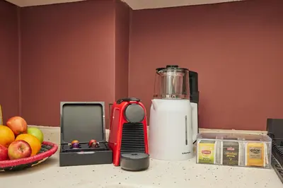 a blender sitting on a counter next to a bowl of fruit at Comfortable 2BR Flat in Nişantaşı Near Metro in Istanbul