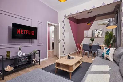 a living room with a couch and a tv at Comfortable 2BR Flat in Nişantaşı Near Metro in Istanbul