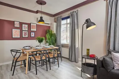 a dining room with a table and chairs and a couch at Modern 2BR in Nisantasi Area Balconies & AC in Istanbul