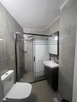 a bathroom with a shower and a toilet and a sink at rema house in Gemlik