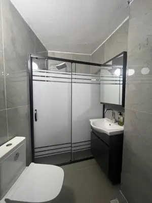 a bathroom with a shower and a toilet and a sink at rema house in Gemlik