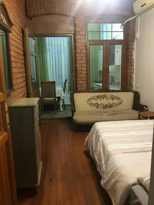 a room with two beds and a couch and a window at Suite with a kitchen near istiklal street in Istanbul