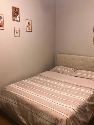 a bed in a bedroom with pictures on the wall at Suite with a kitchen near istiklal street in Istanbul