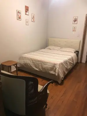 a bedroom with a bed and a chair and a table at Suite with a kitchen near istiklal street in Istanbul