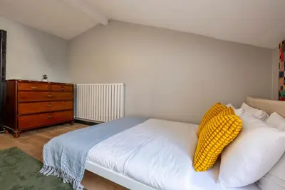 a bedroom with a white bed and a dresser at Central 4-Bedroom House with Private Terrace and 2 Bathrooms in Istanbul