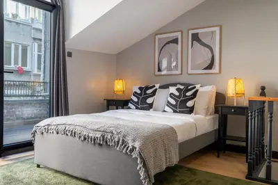 a bedroom with a bed and a large window at Central 4-Bedroom House with Private Terrace and 2 Bathrooms in Istanbul