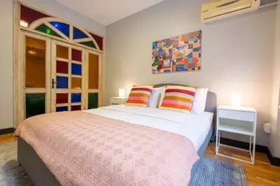 a bedroom with a large white bed with colorful pillows at Central 4-Bedroom House with Private Terrace and 2 Bathrooms in Istanbul