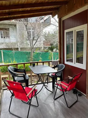 a patio with a table and chairs on a porch at Ciğ Bungalov Airport in Arnavutköy