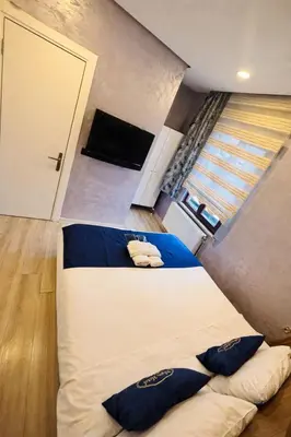 two beds in a small room with a television at Heart of Pera by Allyon Suite Hotel in Istanbul
