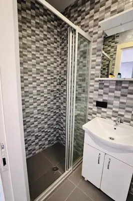 a bathroom with a shower and a sink at Heart of Pera by Allyon Suite Hotel in Istanbul