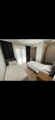 a bedroom with two beds and a window at nişanesi sita in Istanbul