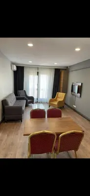 a living room with a couch and a table and chairs at nişanesi sita in Istanbul