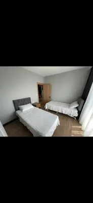 a bedroom with two beds and a couch at nişanesi sita in Istanbul