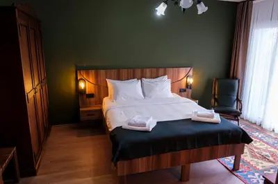 a bedroom with a bed with two towels on it at Terrazzo Sapanca - Isıtmalı Havuzlu Villa Süha Fazlı in Sapanca