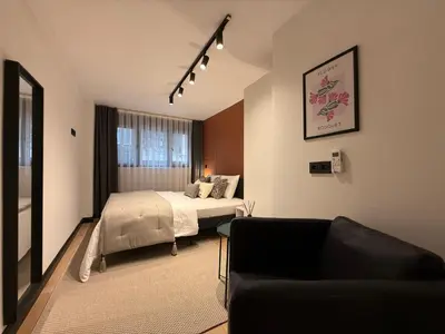 a hotel room with a bed and a couch at Stunning Combo Flat in Nisantasi in Istanbul