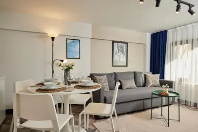 a living room with a couch and a table and chairs at Stunning Combo Flat in Nisantasi in Istanbul