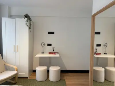 a room with two tables and stools and a mirror at Stunning Combo Flat in Nisantasi in Istanbul