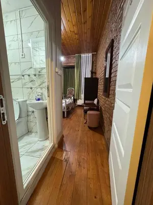 a hallway with a bathroom with a sink and a tub at Naila ahmadreza in Istanbul