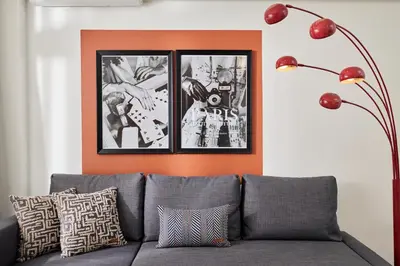 a couch in a living room with three pictures on the wall at Bright & Modern 2-Bedroom Flat Near Metro in Istanbul