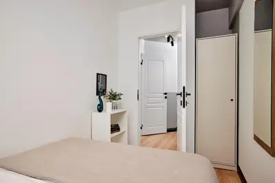 a bedroom with a bed and an open door at Stylish 2BR in Central Istanbul 3-Min to Metro in Istanbul