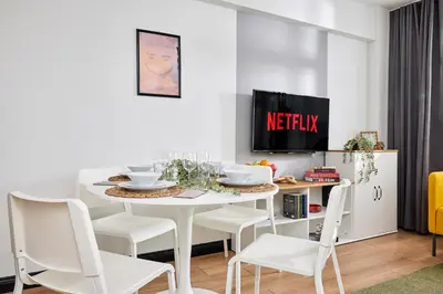 a white dining room with a white table and chairs at Stylish 2BR in Central Istanbul 3-Min to Metro in Istanbul