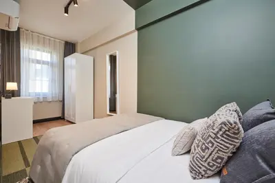 a bedroom with a white bed and a window at Heart of the City 3 Min to Metro 2BR AC in Istanbul
