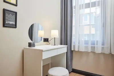 a bathroom with a white vanity and a mirror at Heart of the City 3 Min to Metro 2BR AC in Istanbul