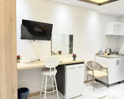 a kitchen with a desk with a tv on the wall at The Blue Mansion Modern Rooms in Istanbul