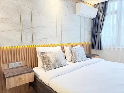 a bedroom with a large bed with white sheets and pillows at The Blue Mansion Modern Rooms in Istanbul