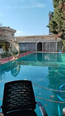 a swimming pool with a chain around it at White garden in Tuzla