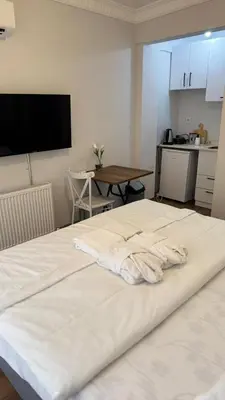 a large white bed in a room with a table at balatlife suites in Istanbul