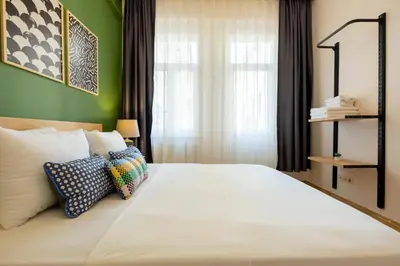 a bedroom with a large white bed with a green wall at 3-Bedroom 2-Bathroom, Centrally Located Ground-Floor Apartment -No Stairs in Istanbul