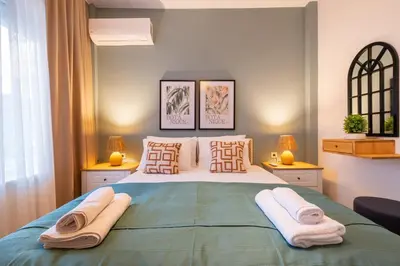 a bedroom with a large bed with towels on it at Fully Renovated 2BR Flat in Center of Moda in Istanbul