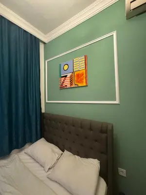 a bed in a bedroom with a picture on the wall at Veva corner suit in Istanbul