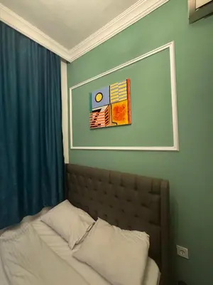 a bed in a bedroom with a picture on the wall at Veva corner suit in Istanbul