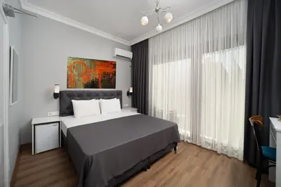a bedroom with a bed and a large window at Kallavi Pera Hotel in Istanbul