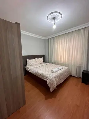 a bedroom with a bed with a white comforter at Metroya 3 dakima uzaklıkta merkezi konumda in Istanbul