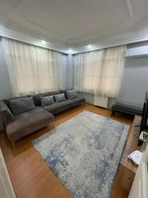 a living room with a couch and a rug at Metroya 3 dakima uzaklıkta merkezi konumda in Istanbul