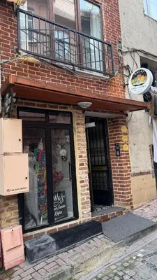 a brick building with a window and a balcony at Balat in Istanbul