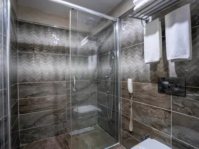 a bathroom with a shower with a glass door at Actuel Life Hotel in Istanbul