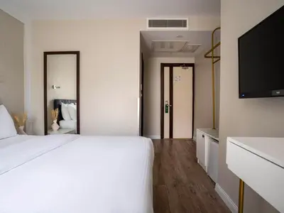 a bedroom with a white bed and a flat screen tv at Actuel Life Hotel in Istanbul