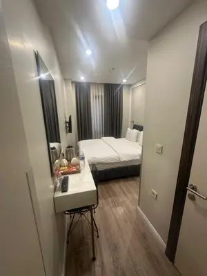 a room with a bed and a table with a mirror at Actuel Life Hotel in Istanbul