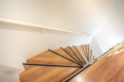 a spiral staircase with wooden floor and white walls at Unique 4-Level Home in the Heart of Beşiktaş in Istanbul