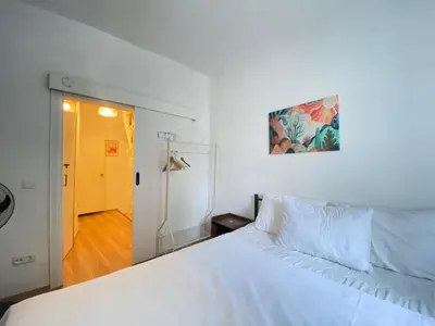 a bedroom with a white bed and a yellow door at Unique 4-Level Home in the Heart of Beşiktaş in Istanbul
