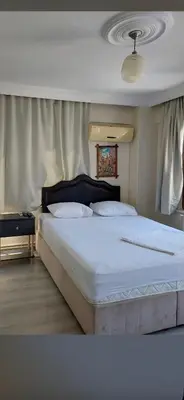 a bedroom with a large bed with white sheets at Huzur Otel Ümraniye in Istanbul
