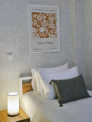 a bedroom with a bed with a picture on the wall at Excellent Apartments Fatih Citadel in Istanbul
